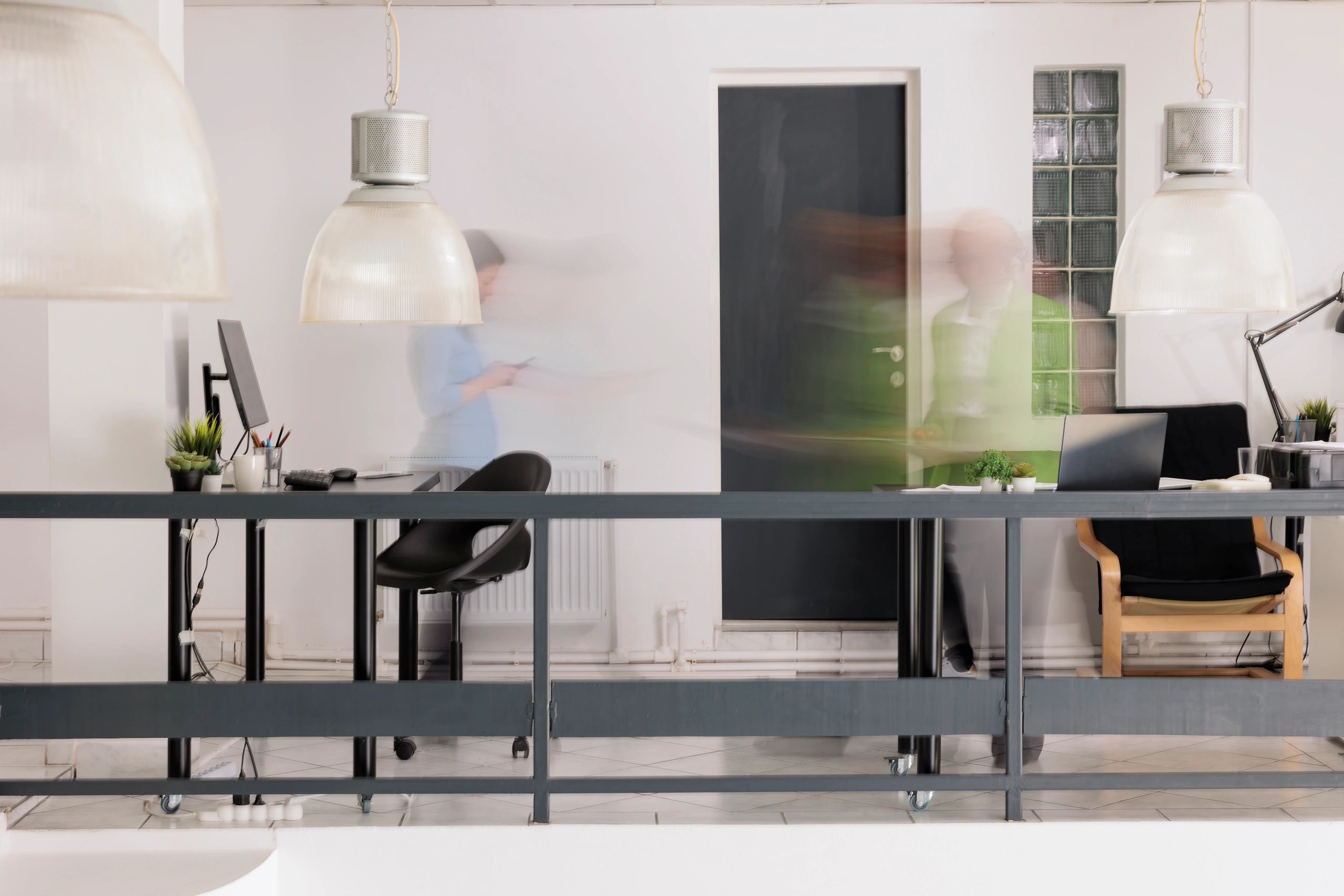 Blurred employees silhouettes walking in coworking space in motion